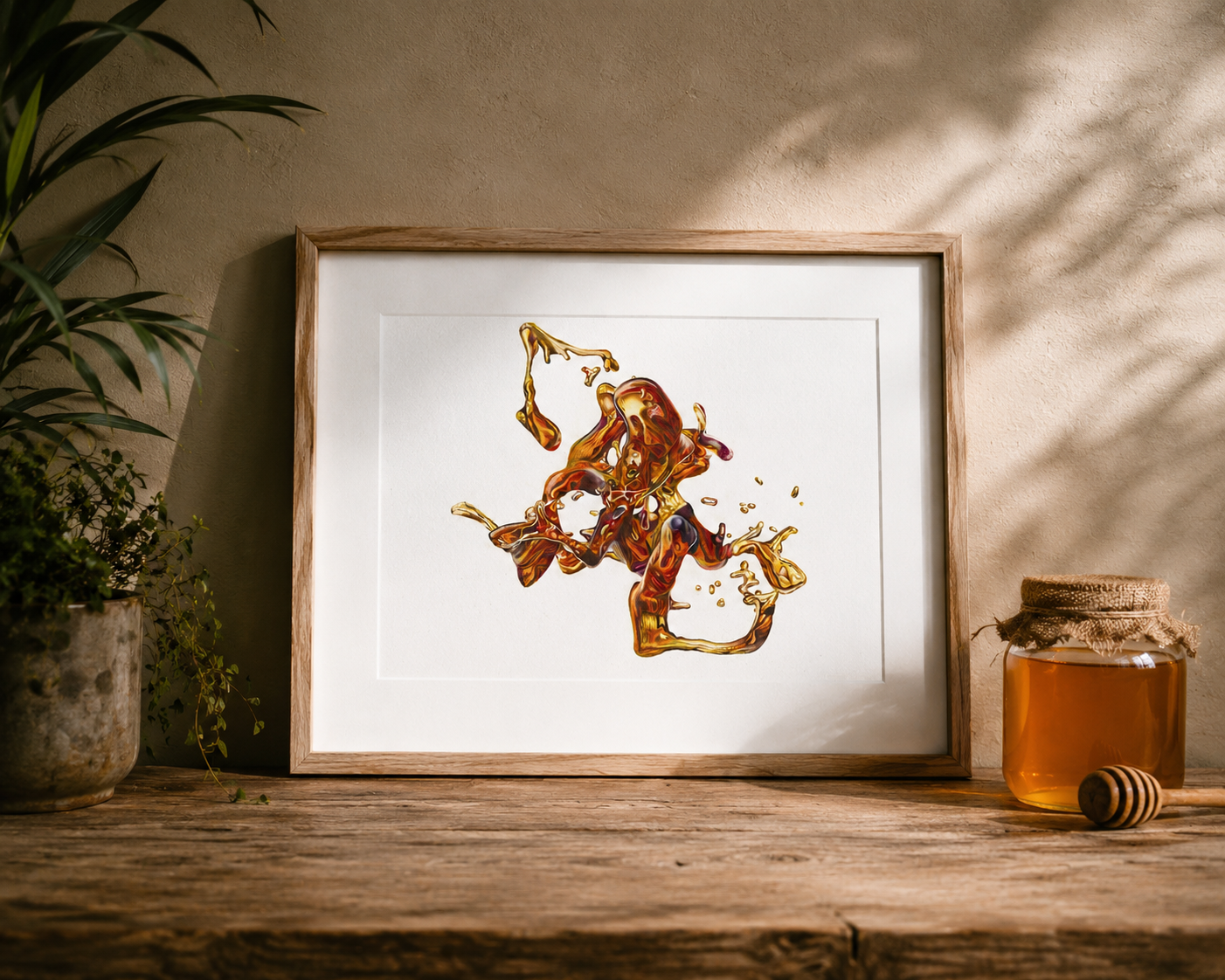 Framed artwork of a honey bee and honeycomb next to a jar of honey on a wooden surface.
